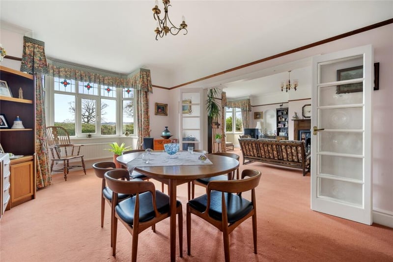 Glass doors leads to this spacious dining room which also has a decorative bay window.