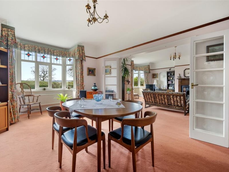 Glass doors leads to this spacious dining room which also has a decorative bay window.
