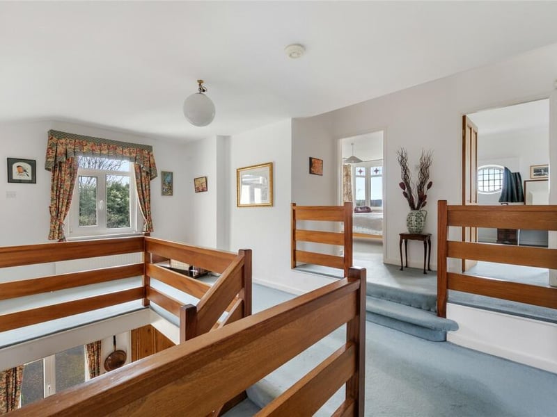Stairs in the hallway lead you to this elegant landing.