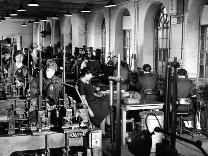 The umbrella department of Samuel Fox and Co's Stocksbridge Works, showing women operating the multi-stage machines used in the making of umbrella ribs and stretches
