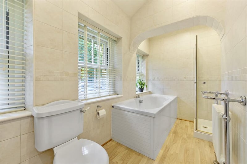 This beautiful house bathroom features a bathtub with separate shower.