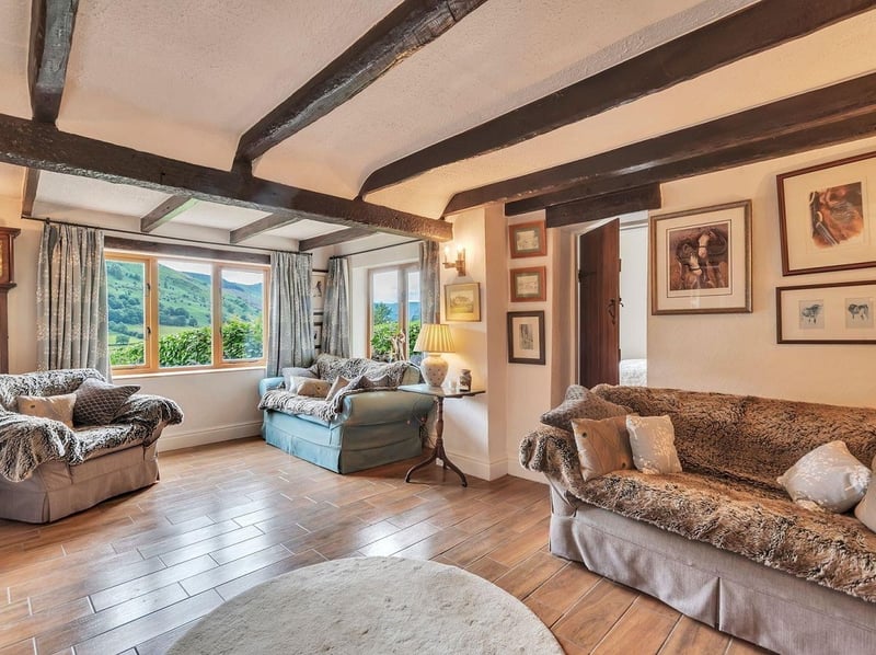 The living room comes complete with beamed ceilings and a fireplace. Picture: Rightmove