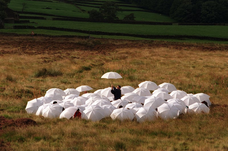 Environmentalists from 54 different countries gathered on Pennistone Hill above Haworth in September 1996 where they tried to spell out 'high and dry' with white umbrellas to highlight the threatened double impact of climate change and misuse of water resources. 