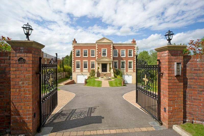 Visitors to the property are welcomed by security gates and then a driveway which opens up to the property.