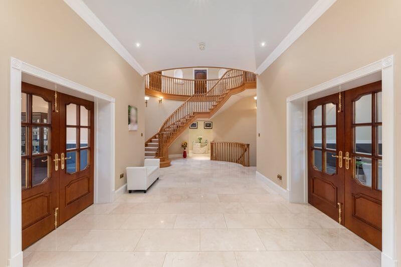 This view of the entrance hall gives an idea at the scale of the property's staircase, which provides access to the home's three levels.