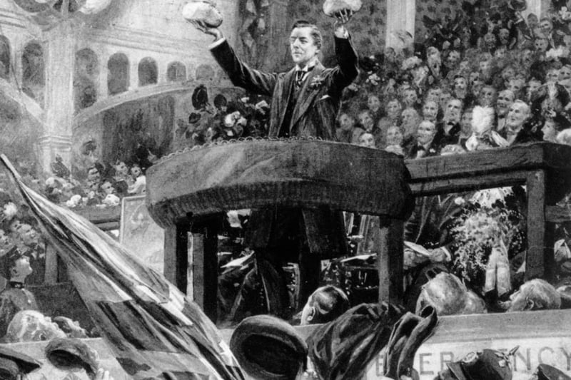 The British statesman, Joseph Chamberlain (1836 - 1914), delivers his speech on 'The Tarriff Question' in Bingley Hall, Birmingham on November 4, 1903. He uses two loaves of bread of varying size to illustrate the difference the tax would make on the loaf. A print from the Illustrated London News. (Photo by Hulton Archive/Getty Images)