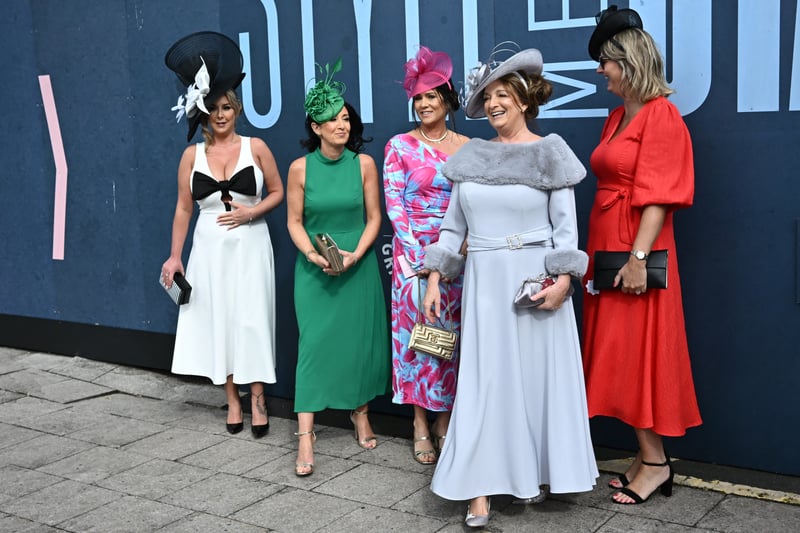 Racegoers don a range of colours and flamboyant fascinators at Aintree.