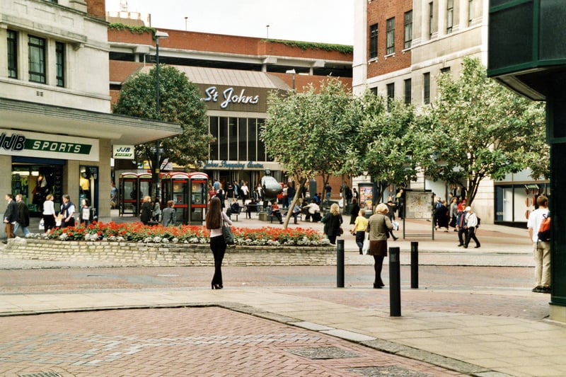 Looking across The Headrow towards Dortmund Square and the entrance to the St John's Centre. JJB Sports store can be seen on the left with Allders department store on the right.