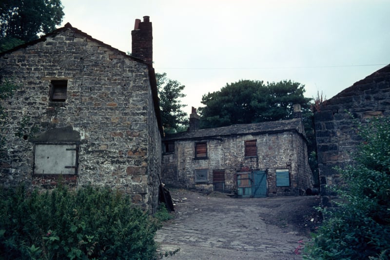Derelict buildings of Woodlands Dyeworks, also known as Crowther's Mill, shortly before demolition. Situated on Wood Lane, the mill is believed to date from about 1601. It was originally a corn mill and previously known as Wood's Mill and Rowley's Mill before being taken over by Edward Crowther in 1906. After the Second World Ward the buildings were left to become derelict until Leeds City Council bought the site, demolished the mill and landscaped the area. Pictured in July 1975.