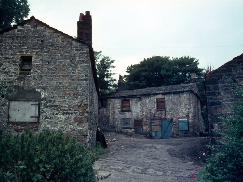 Derelict buildings of Woodlands Dyeworks, also known as Crowther's Mill, shortly before demolition. Situated on Wood Lane, the mill is believed to date from about 1601. It was originally a corn mill and previously known as Wood's Mill and Rowley's Mill before being taken over by Edward Crowther in 1906. After the Second World Ward the buildings were left to become derelict until Leeds City Council bought the site, demolished the mill and landscaped the area. Pictured in July 1975.