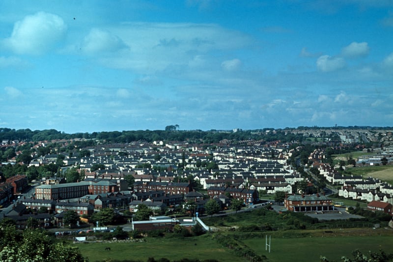 Aerial view of Meanwood from Woodhouse Ridge, looking across a rugby ground and fields towards Grove Lane running along the bottom. The Meanwood Hotel pub  is on the bottom right at the junction with Meanwood Road. Bentley Lane runs up on the far left with Bentley Primary School on its right hand side, while Stainbeck Road runs up on the right. Much of the housing in between the two, mainly terraces, has since been demolished and replaced by semi-detached housing. Pictured in June 1973..