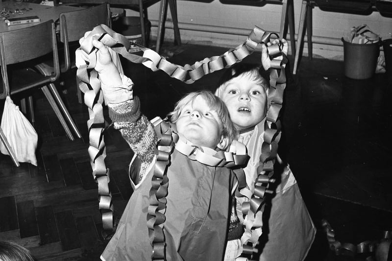 These young pupils were chipping in with making Christmas decorations at St Paul's School in November 1973.
