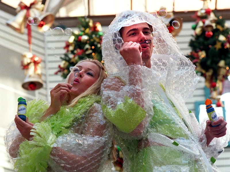 Models Michael Morton and Mel Mansell wear outfits made from bubble wrap for the launch of a new mobile phone store Bubble in November 1999.