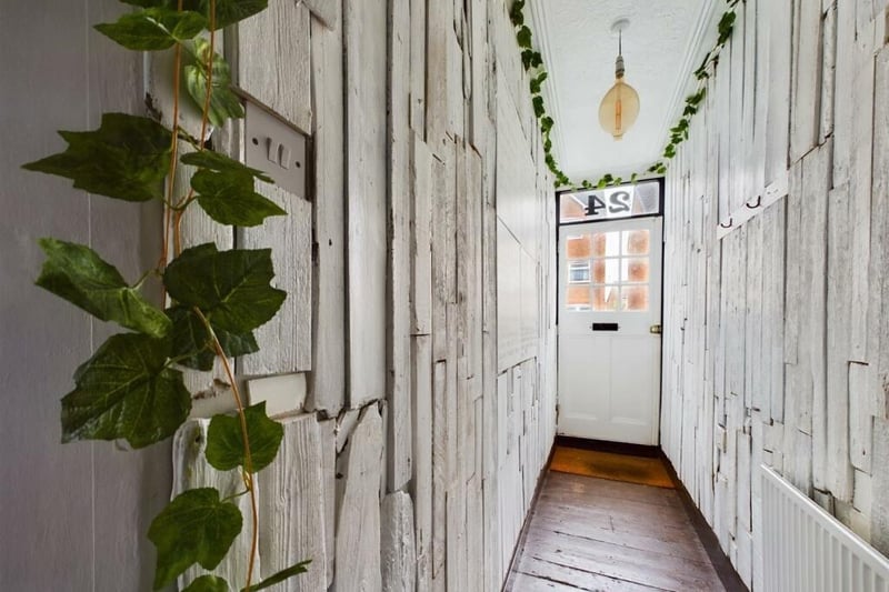 A driftwood clad hallway hints at the quirky nature of what lies within.
