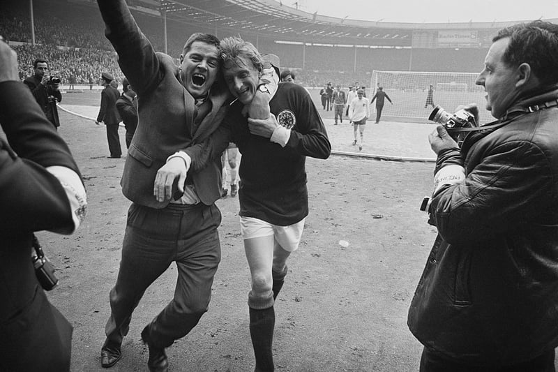 Denis Law is hugged by a Scotland fan after the famous victory over England at Wembley.