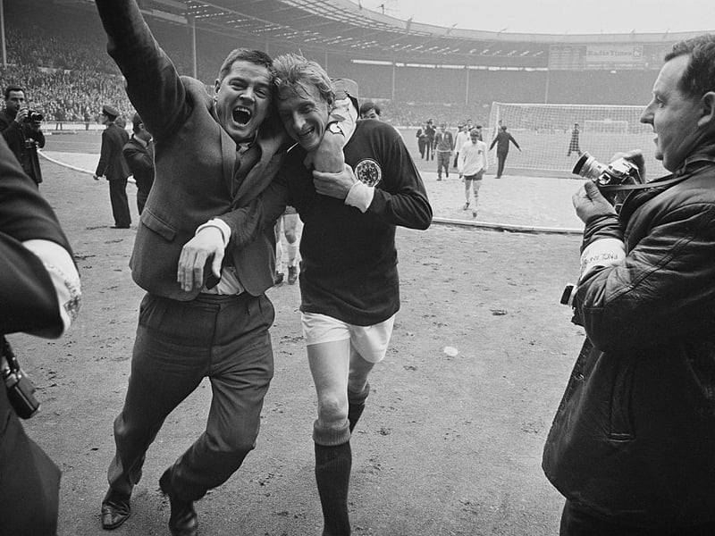 Denis Law is hugged by a Scotland fan after the famous victory over England at Wembley.
