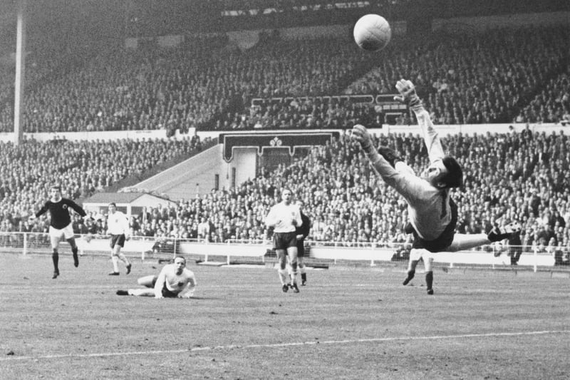 Denis Law sees a shot saved by Gordon Banks in the England goal.