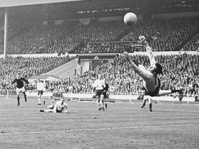 Denis Law sees a shot saved by Gordon Banks in the England goal.