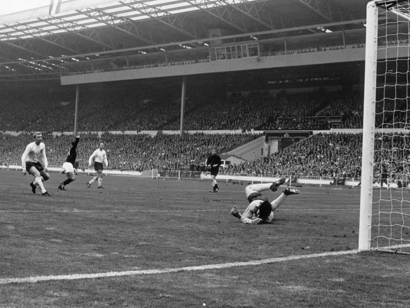 Bobby Lennox turns to celebrate scoring Scotland's second goal.