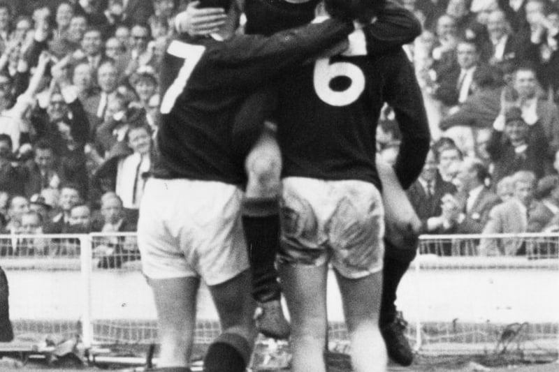 Bobby Lennox is congratulated by team mates Willie Wallace (left) and Jim Baxter after scoring Scotland's second goal at Wembley in the 78th minute.
