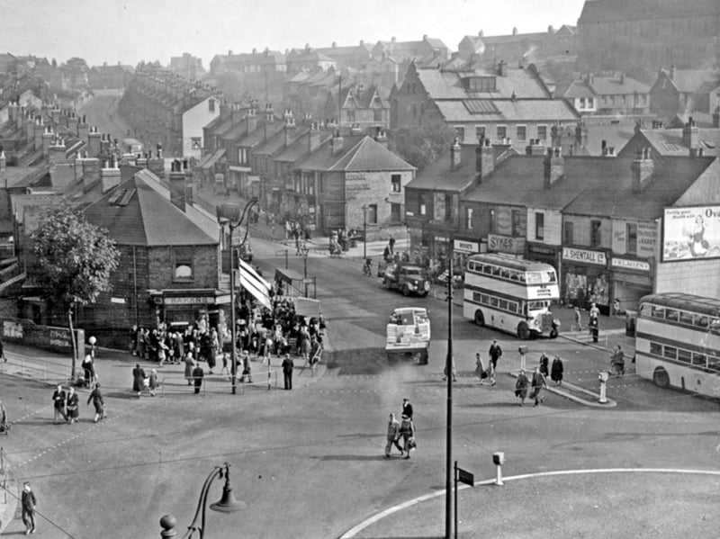 An elevated view of Bellhouse Road, Sheffield, in 1947, looking towards the Flower Estate, with shops, the National Provincial Bank, Wharncliffe Hotel and St. Hilda's Church all visible