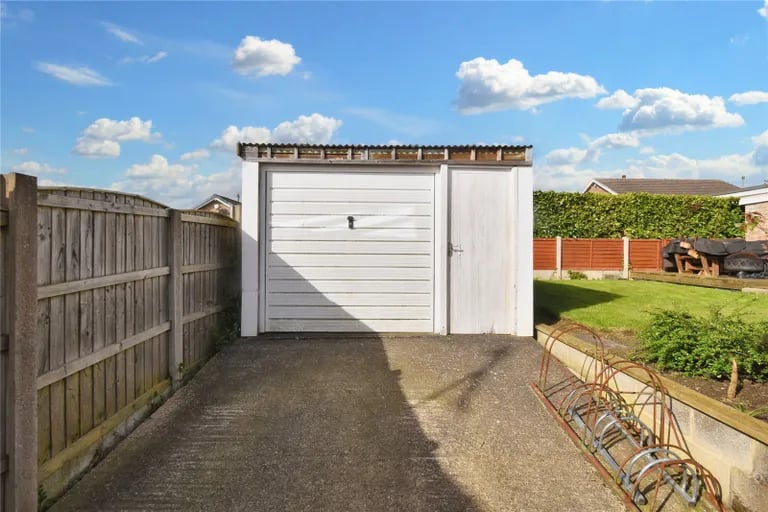 There is also a single garage with access from the driveway.