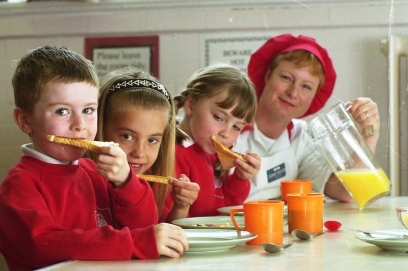 Breakfast club at Barnes School in May 1999. Pictured left to right are Paul Collins, five; Tania Abidi, six; Bethany Longville, five; and school cook Julie Davison.
