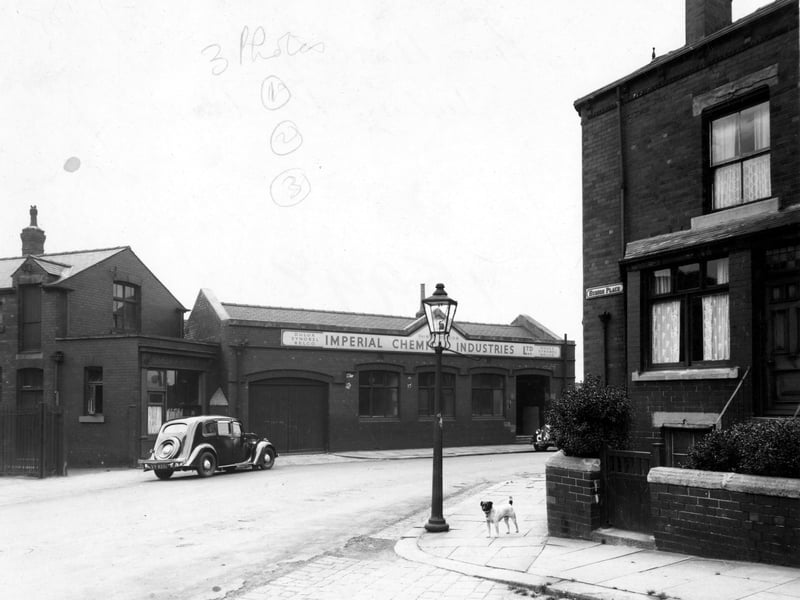 Premises of Imperial Chemical Industries Ltd (ICI), paints division, on Hudson Road viewed from Hudson Place. On the left of ICI is Pickup and Smith's bakers shop. There is a car parked outside the shop. In view is the bay window and small walled garden of the first house in the terrace on Hudson Place. There is a lamp post and a dog on the corner of the street. Pictured in July 1958.