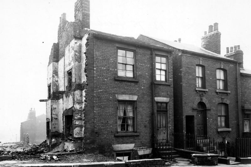 The front of number 73 to 79 Freehold Street, just off York Road. The adjoining house to number 73 has been demolished, leaving the outline of its floors on the gable end. Pictured in March 1949.
