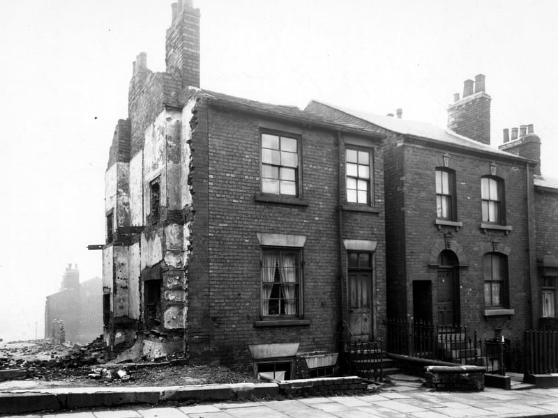 The front of number 73 to 79 Freehold Street, just off York Road. The adjoining house to number 73 has been demolished, leaving the outline of its floors on the gable end. Pictured in March 1949.