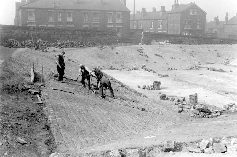 Construction of static water supply basin which was built as a temporary wartime measure on Beckett Street recreation ground. Houses on Burns Street can be seen in background. Pictured in June 1942.