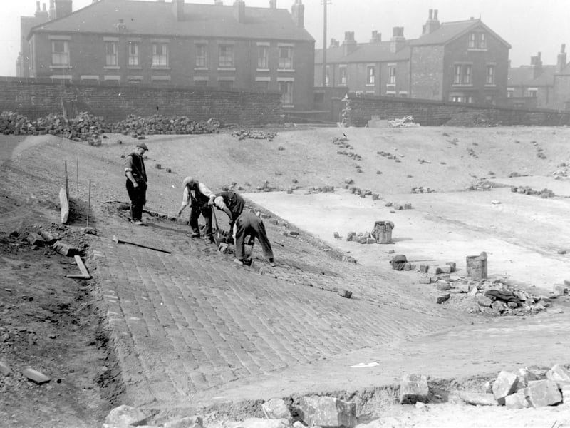 Construction of static water supply basin which was built as a temporary wartime measure on Beckett Street recreation ground. Houses on Burns Street can be seen in background. Pictured in June 1942.