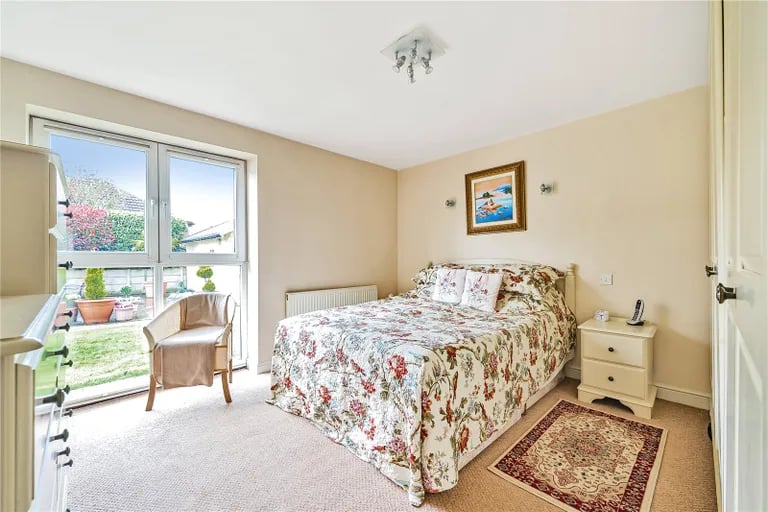 There are two bedrooms on the ground floor, with this spacious double room benefitting from built-in wardrobes, French doors leading onto the garden and en-suite shower room.