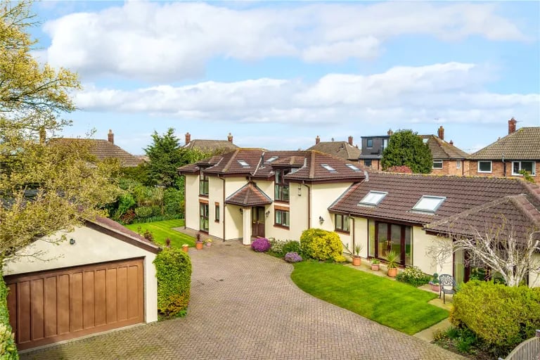 The gardens are secluded and features a large winding driveway, a separate garage and a charming summer house along with lawns, hedging and shrubbery.