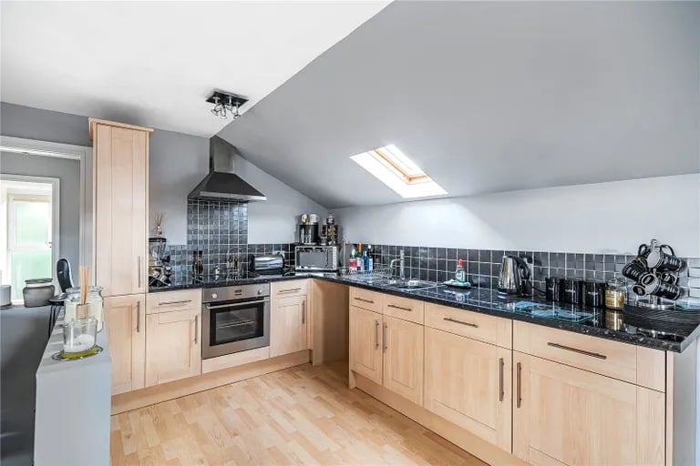 Here is a stylish fitted kitchen with skylight.