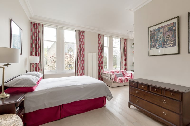 The bright and airy principal bedroom benefits from a walk-in wardrobe.