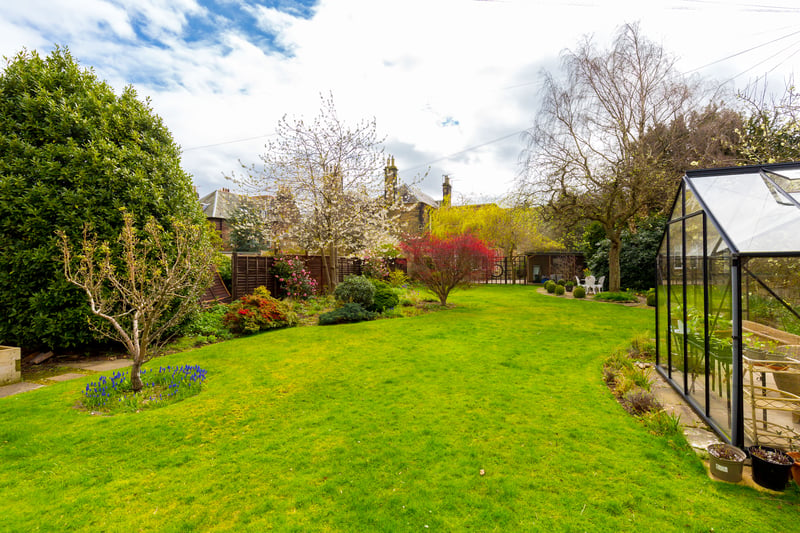 On the west side, a driveway leads to a double garage and a delightful large rear garden, which has been beautifully maintained and benefits from a greenhouse and patio area.