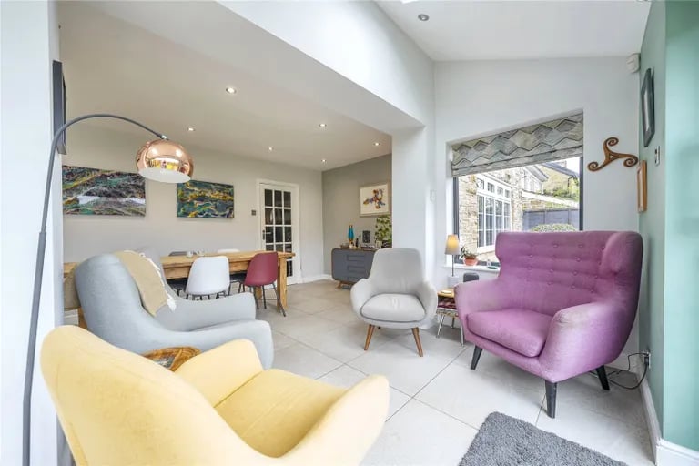 The extended room has plenty of space for seating areas and large dining tables.