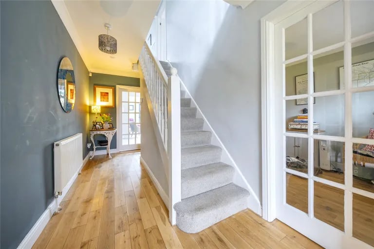 The ground floor hallway has a guest WC and stairs to the first floor.