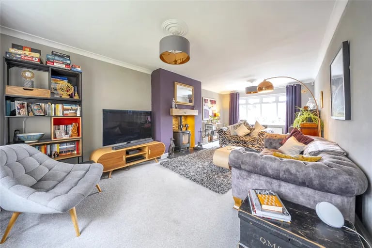Off the hallway is a spacious double aspect living room with wood burner.
