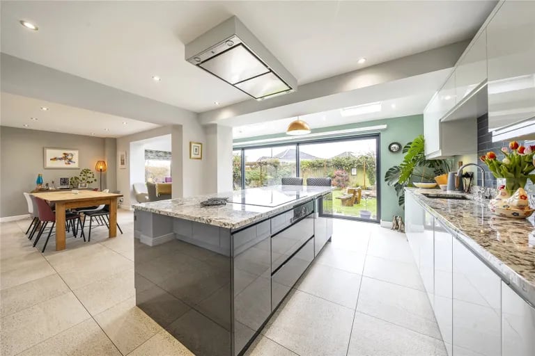 The large open dining kitchen has underfloor heading and has been extended to the rear with glass doors opening onto the garden.