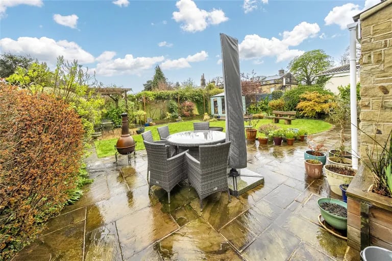 The sunny garden has a paved terrace across the rear of the house.
