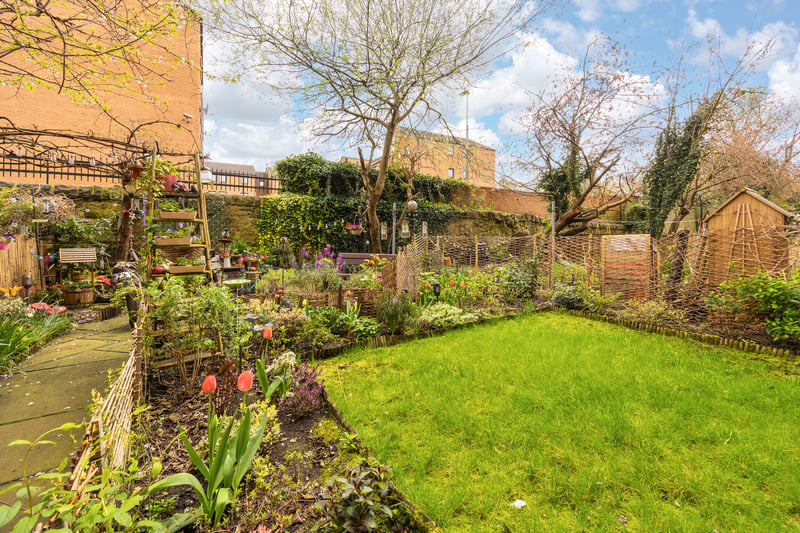 Access to a well-kept communal garden, with decorative shrubbery and stone built wall adding additional privacy.