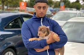Burham Ali with Sniper as a puppy. Burham is clinging to hopes his XL Bully is still alive, amid reports he was destroyed after an armed police raid on a house in Sheffield. Picture: Burham Ali