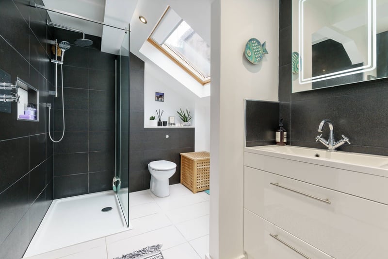 The master bedroom's stylish en-suite shower room with twin sinks.