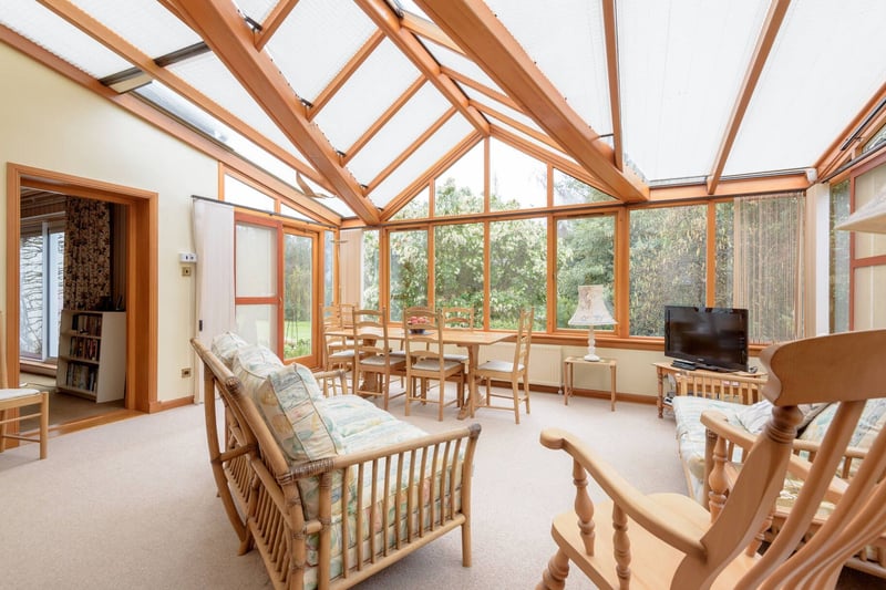 This well maintained home has been cleverly designed to take advantage of the stunning views over the extensive grounds. Pictured is the top-quality conservatory linking the kitchen and dining room with ample room for a sofa and relaxed dining area.