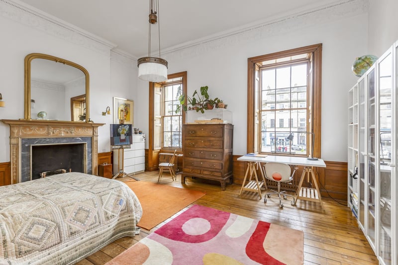 The property boasts three double bedrooms, each offering a tranquil retreat from the bustling city streets. High ceilings soar overhead, accentuating the sense of space and airiness.