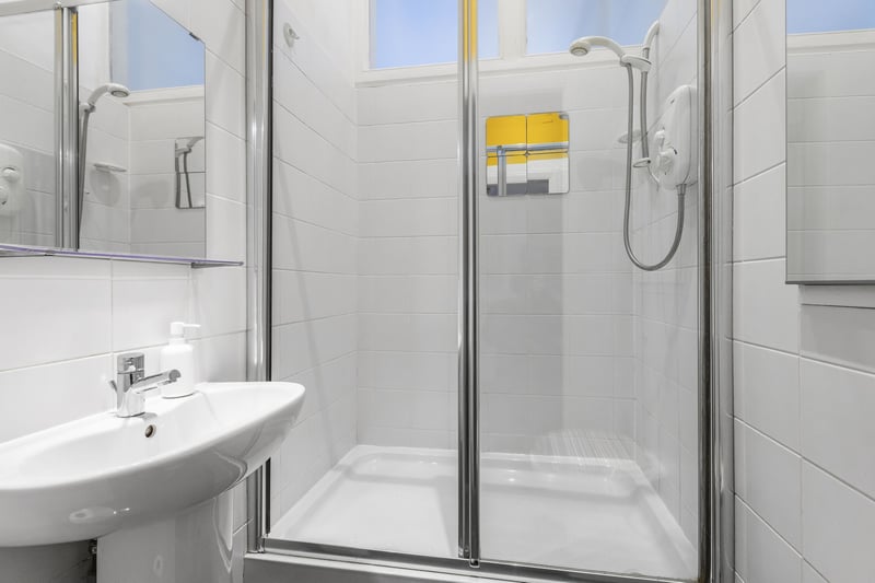 A separate shower room offers added convenience for busy mornings or indulgent spa-like experiences.