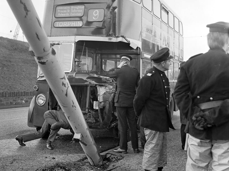Police and an Edinburgh City Transport employee look at the damage after a number 9 bus crashed into a lamppost in Granton in November 1974.