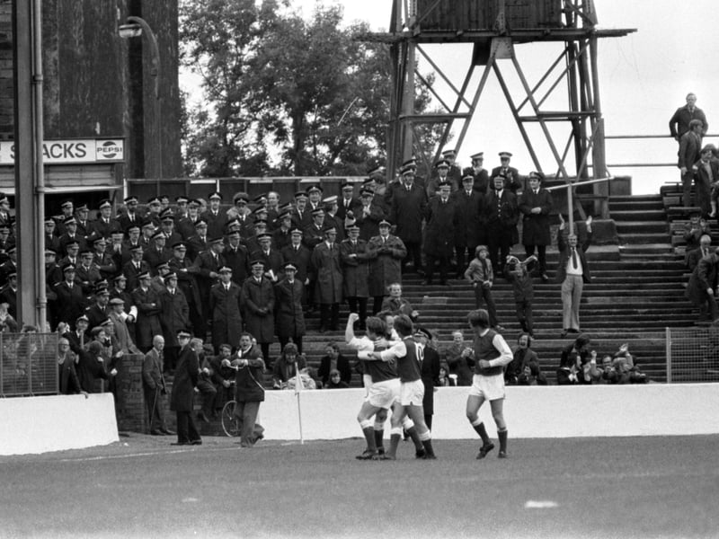 The Hibs v Hearts derby at Easter Road in September 1975 - a huge police presence as the Hibs team celebrates a goal.